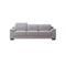 SOFA ESTACIONARIO DE TRES ASIENTOS EN FRENTE DE PIEL GRIS Y PATAS NEGRAS