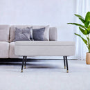 BANCO EN TELA BEIGE CON PATAS NEGRAS CON CASQUILLOS DORADOS