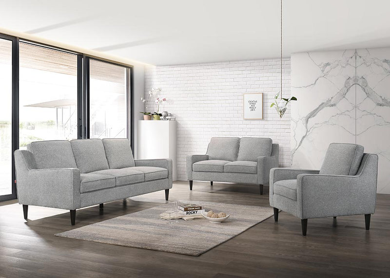 SOFA ESTACIONARIO DE TRES ASIENTOS  TAPIZADO EN TELA GRIS Y PATAS NEGRAS HS304